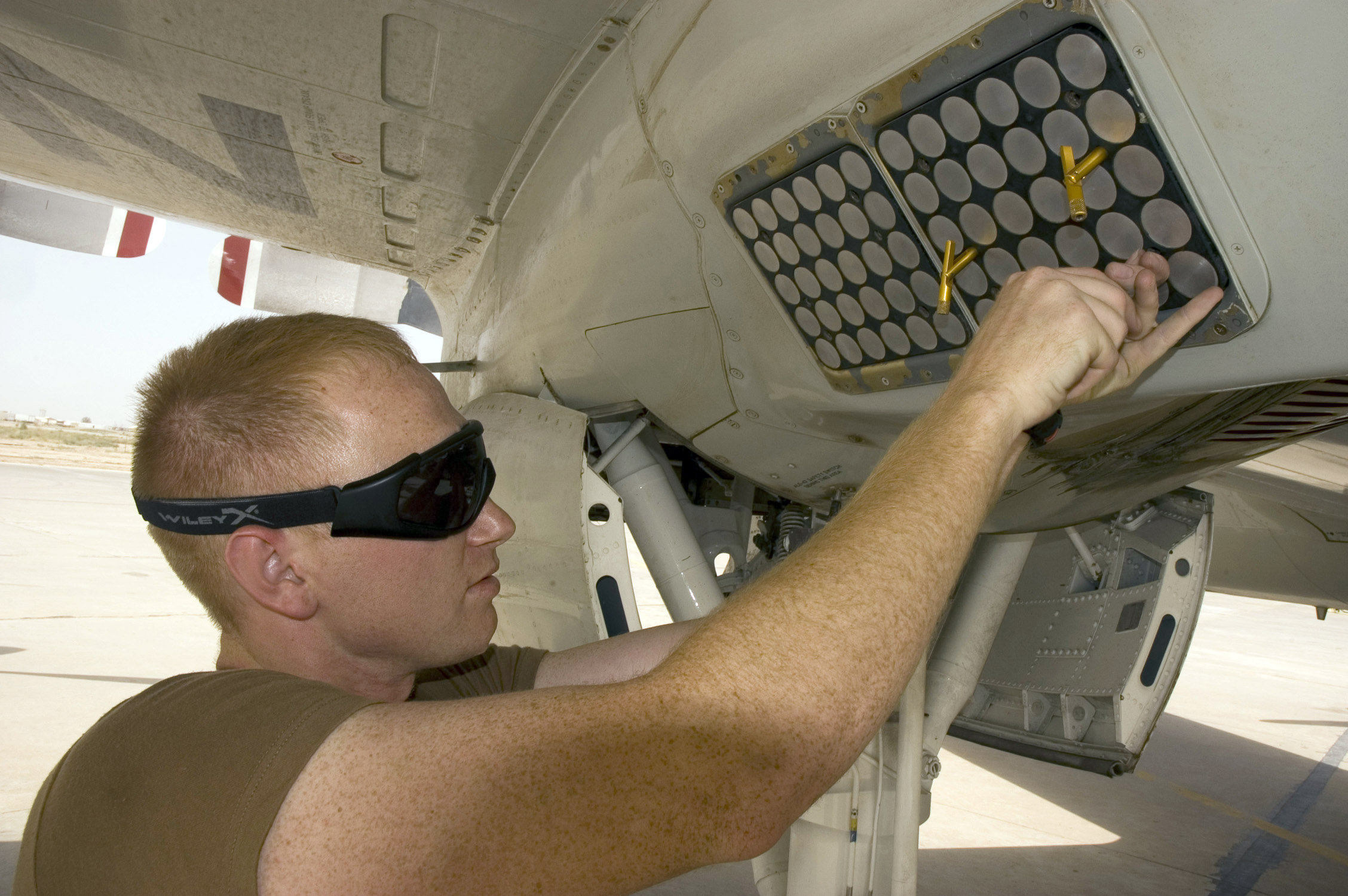 AN/ALE-47 decoy dispenser being installed aboard a USN P-3C Orion maritime patrol aircraft